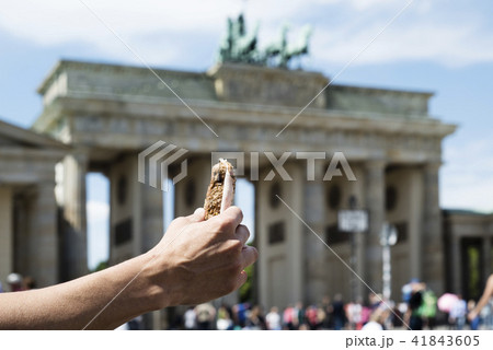 man eating a sandwich on the Brandenburg Gate. man eating a sandwich on the Brandenburg Gate. 41843605