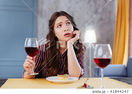 Depressed businesswoman talking to her friend during dinner Depressed businesswoman talking to her friend during dinner 41844247