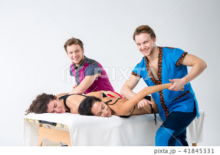 Theme massage and body care. Two young male twin brothers with a beard and uniform make a tandem 41845331