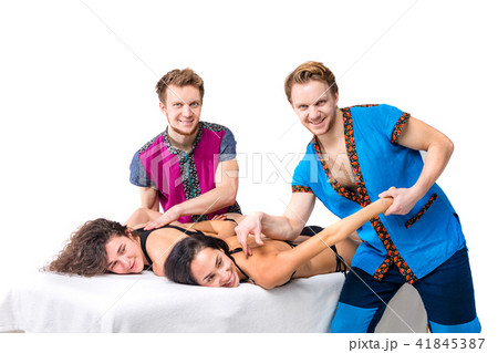 Theme massage and body care. Two young male twin brothers with a beard and uniform make a tandem Theme massage and body care. Two young male twin brothers with a beard and uniform make a tandem 41845387