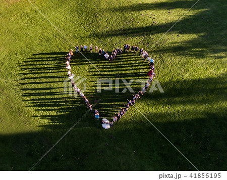 Wedding guests lined up in the shape of heart with bride and groom marriage people Wedding guests lined up in the shape of heart with bride and groom marriage people 41856195