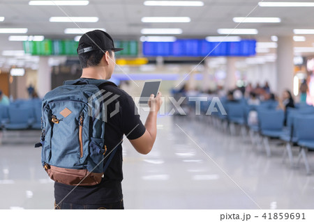 young man at the airport terminal Traveling young man at the airport terminal Traveling 41859691