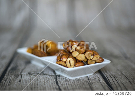 Peanut candy dish filled with white and almond des Peanut candy dish filled with white and almond des 41859726