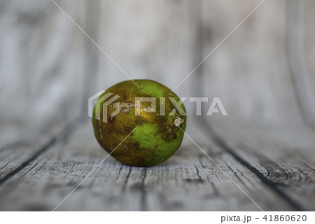 rotten green lemon put on wooden table rotten green lemon put on wooden table 41860620