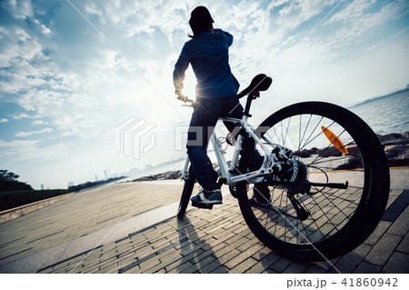 cyclist looking at the beautiful landscape coast cyclist looking at the beautiful landscape coast 41860942