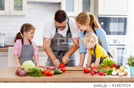 happy family with children preparing vegetable salad . happy family with children preparing vegetable salad . 41867014