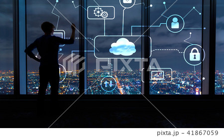 Cloud computing with man by large windows at night 41867059