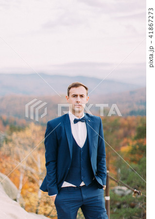 Half-length portrait of the groom at the blurred background of the yellowed forests. 41867273