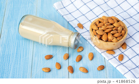Almond milk on a blue wooden table. 41868526