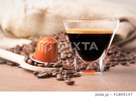 A cup of coffee and capsule coffee close up A cup of coffee and capsule coffee close up 41869147