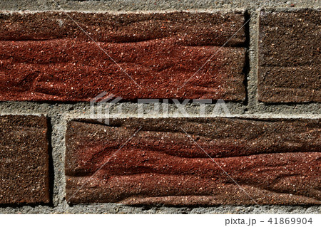 Wall of a brick house in gray-red color, texture, background 41869904