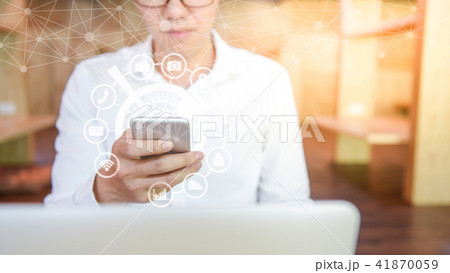 Businessman using smartphone with glowing hologram Businessman using smartphone with glowing hologram 41870059
