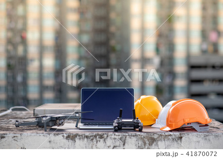 Drone, laptop and helmet at construction site Drone, laptop and helmet at construction site 41870072