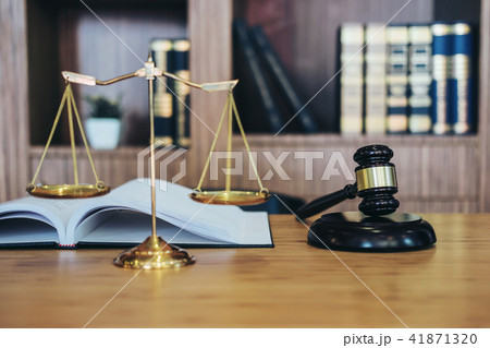 Scales of justice and Gavel on sounding block and law book to wo 41871320