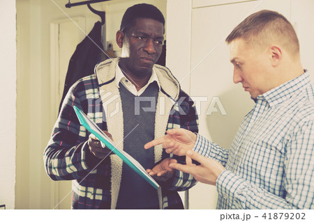 Two worried men with documents, having conflict about services Two worried men with documents, having conflict about services 41879202