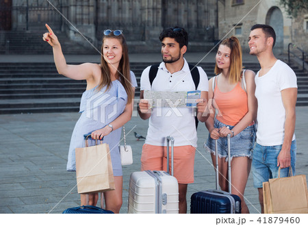 Group of young traveling people using paper map in city 41879460
