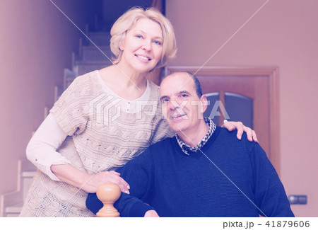 Happy spouses leaning against stairway 41879606