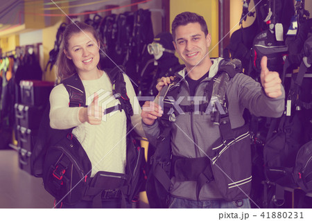 Young woman and man are satisfied of diving vest Young woman and man are satisfied of diving vest 41880231