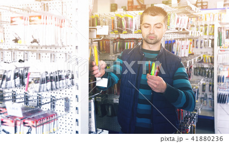 guy is considering fishing lures 41880236