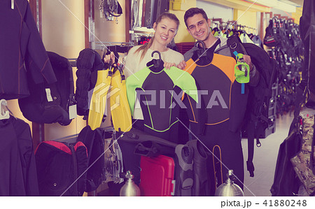 woman and male with diving equipment woman and male with diving equipment 41880248