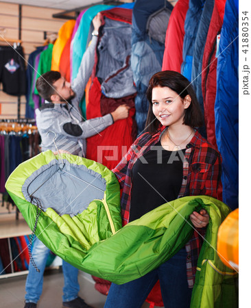 Woman shoosing new sleeping bag 41880354