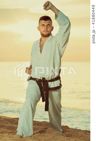 Adult guy practising karate kata poses Adult guy practising karate kata poses 41880449