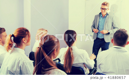 Nice male teacher lecturing to students Nice male teacher lecturing to students 41880657