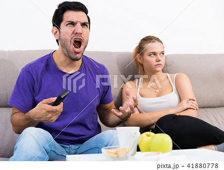 Man watching tv ignoring frustrated girl 41880778