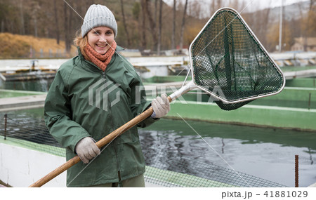 Woman with landing net on fish farm 41881029