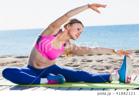 Smiling adult woman is practicing yoga 41882121