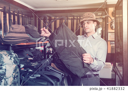 Portrait of adult man hunter looking hunt equipment Portrait of adult man hunter looking hunt equipment 41882332