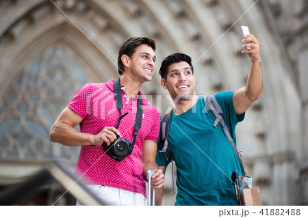 Men are walking with suitcases and making selfie 41882488