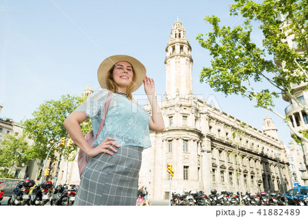 Young emotional female in hat glad posing in the historical city center Young emotional female in hat glad posing in the historical city center 41882489