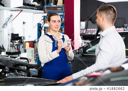 Female mechanic discussing with male client 41882662