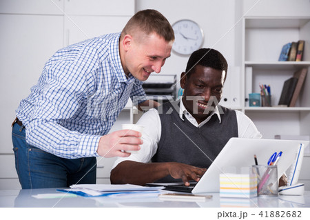 Two men working with computer in office Two men working with computer in office 41882682