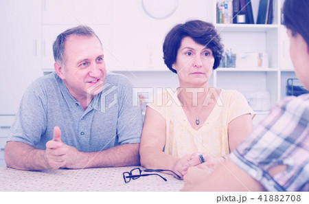 Senior mature man and woman listening to young woman Senior mature man and woman listening to young woman 41882708