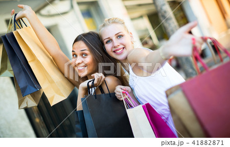 women walking with shopping bags 41882871