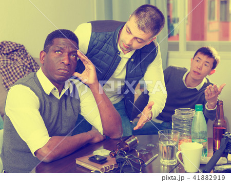 Chagrined man with friends Chagrined man with friends 41882919