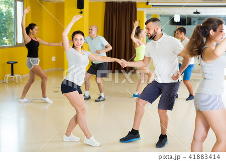 Men and women are dancing boogie-woogie in pairs Men and women are dancing boogie-woogie in pairs 41883414