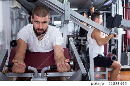 Man training on fitness machine in gym 41883446