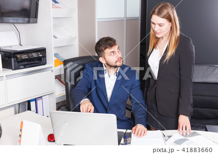 Female and male sales managers working on laptop Female and male sales managers working on laptop 41883660