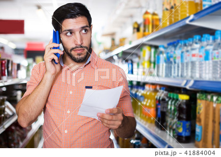 man is choosing mineral water 41884004
