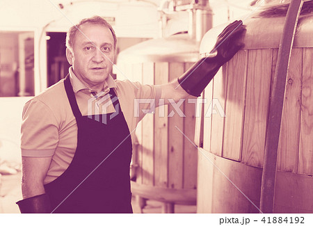Portrait of brewer who is standing on his workplace 41884192