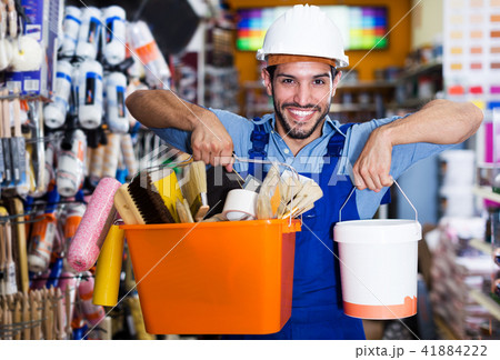 Handyman choosing rollers and varnishes 41884222