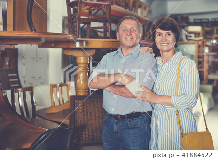 Man with wife are choosing antique furniture Man with wife are choosing antique furniture 41884622