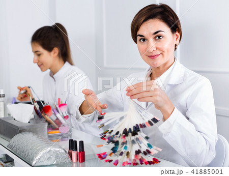 Female manicurist showing lacquer color schemes 41885001