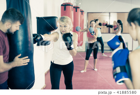 mature woman who is training with punching bag mature woman who is training with punching bag 41885580