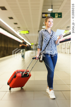 Girl traveler with booklet walking at underground station 41886016