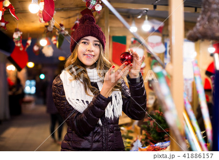 Woman choosing Christmas decoration at market 41886157