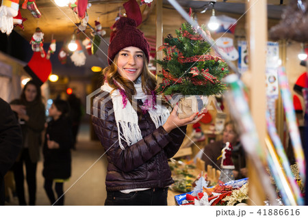 Woman customer choosing Christmas tree outdoor 41886616